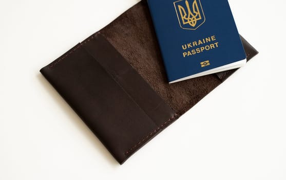 Ukrainian passport with a leather cover on a white background, selective focus. Inscription in Ukrainian Ukraine Passport.