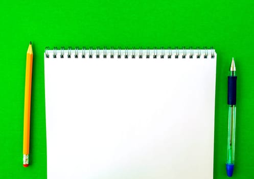 White notepad with spring, pen and pencil. 