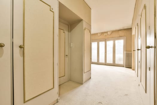 the hallway of an empty apartment with doors and windows