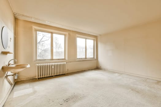 an empty living room with a sink and a window
