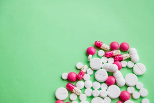 colorful pills and drugs in close up.assorted pills and capsules in medicine. drugs of various kinds and different colors. Medicine on green background