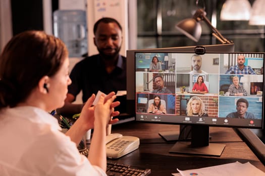 Office manager talking with employees on videocall meeting