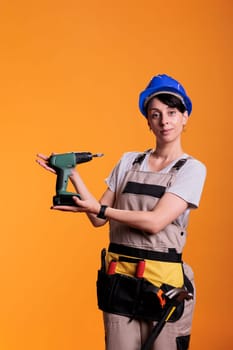 Woman contractor showing cordless screw gun