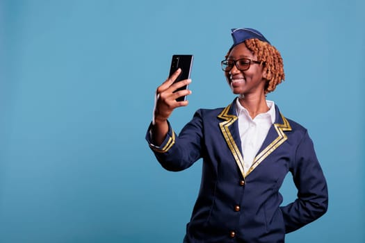 Flight attendant having video call with mobile phone.