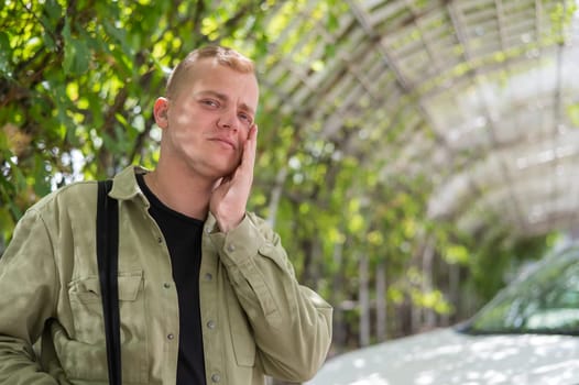 Sad caucasian man with hearing aids outdoors.