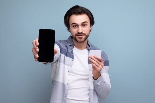 young brunette man with smartphone mockup and money card
