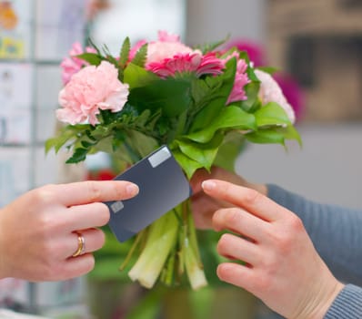 Hands, flowers and credit card for shopping in florist shop, small business or store for purchase. Plastic money, floral bouquet and customer paying, buying or payment for sale of natural plants.