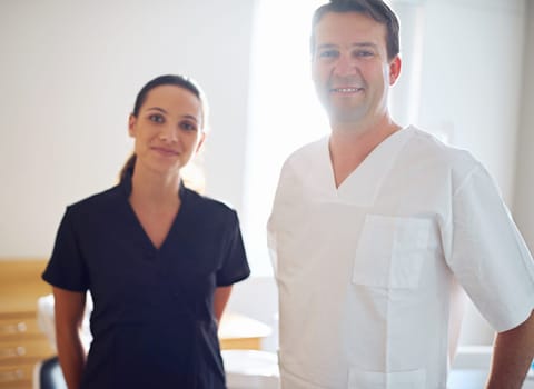 Always great to see your smile around the office. Cropped portrait of a dentist standing with his assistant