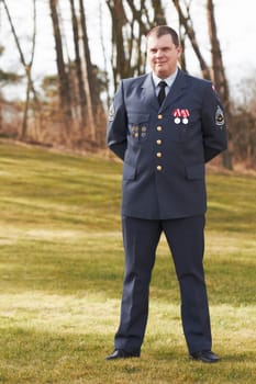 Portrait, Denmark and veteran general or official in uniform or flag on sleeve and male soldier outdoors. Danish military, hero and badge of honor or man officer or security and courage for war