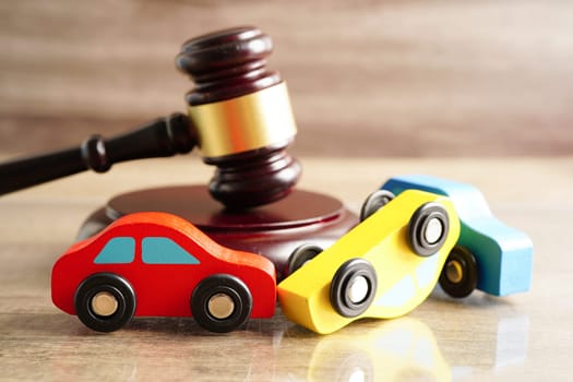 Bangkok, Thailand March 15, 2023 Car accident lawsuit and insurance, Judge hammer with car model.
