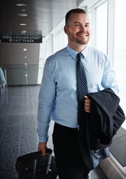 This business trip is going great so far. an executive businessman walking through an airport during a business trip