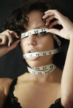 Anorexia, measuring tape and cover with face of woman for eating disorder, weight loss and fear. Diet, frustrated and mental health with female for anxiety, stress and bulimia problem or issue