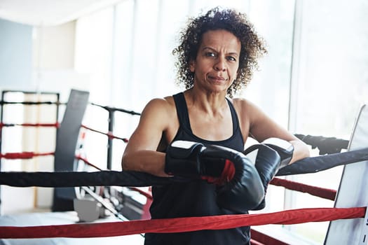 There can only be one winner. Portrait of a mature woman training in a boxing ring.