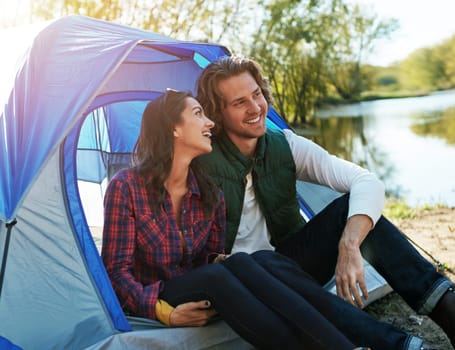 If your relationship can survive camping, it can survive anything. an adventurous couple out camping together.