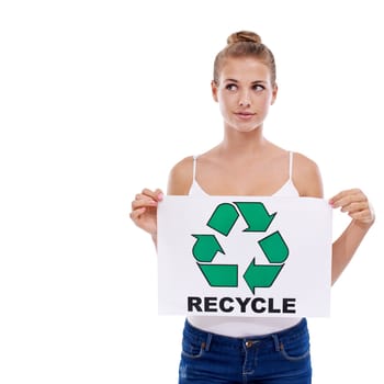Shes got a personal cause. A young teen girl looking away while holding a recycling sign.
