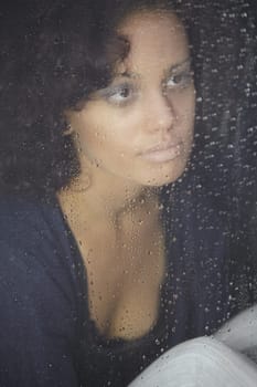 Sad, rain and depression with woman by window for thinking, tired and lonely. Anxiety, mental health and exhausted with female contemplating at home for broken heart, disappointed and fear mockup