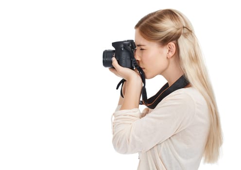 Freeze the moment. A beautiful young photographer standing with her camera against a white background.