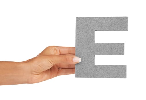 Learning the alphabet E. A young woman holding a capital letter E isolated on a white background.