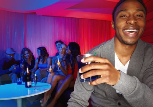 He loves meeting new people. A handsome african american man enjoying drinks while out clubbing with his friends.