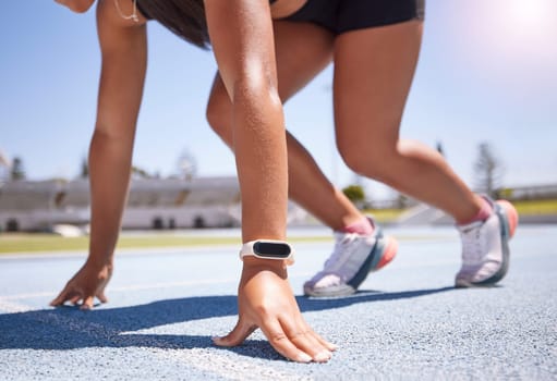 Hands, race and runner with a sports woman on track ready to start an endurance or cardio workout for competitive training. Smartwatch, fitness and exercise with a female athlete running for sport