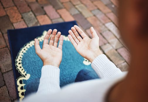 Hands, islam and praying in worship to Allah, god or creator on salah mat making dua on the floor. Hand of islamic man in pray for muslim religion, spiritual or respect for belief or culture outside