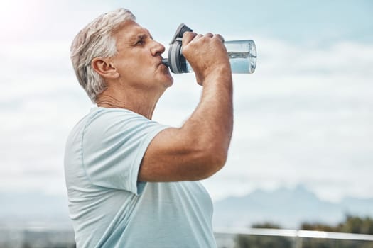 Senior man, fitness and drinking water for hydration or thirst after workout, exercise or training in nature. Elderly male having refreshing natural liquid drink from intense cardio in the outdoors