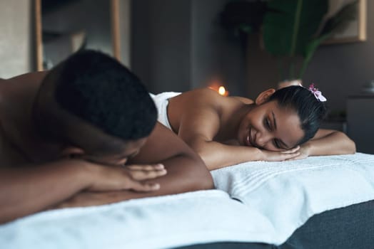 Topping off their honeymoon with a relaxing massage. a young couple relaxing on massage beds at a spa.
