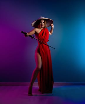 sexy girl in a red cape and an Asian hat with a katana in her hand in neon lights on a copy paste background