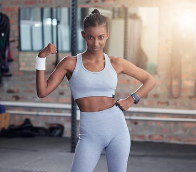 Woman, fitness and portrait flexing bicep for empowerment, exercise or workout at the gym. Portrait of serious female in flex showing arm muscle, strength or power for healthy wellness at health club