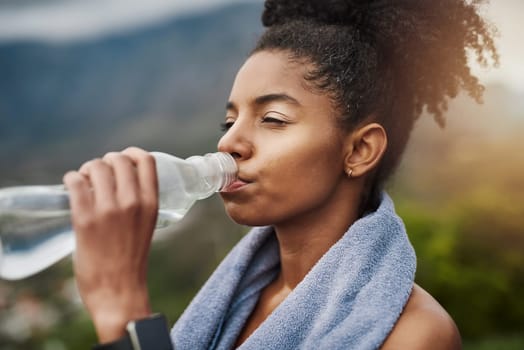 Hydration is vital for your performance. a sporty young woman drinking water while exercising outdoors.