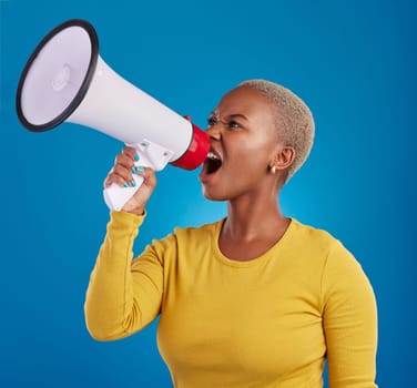 Megaphone, shouting and angry black woman in studio for message, broadcast or vote on blue background. Speaker, microphone and girl protest for change, democracy and justice, noise and womens rights