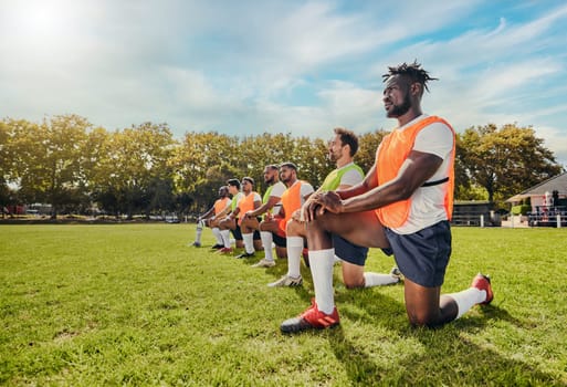 Sports, training and team outdoor for rugby on a grass field with men doing knee exercise. Athlete group together for fitness and workout for professional sport with diversity, support and teamwork.