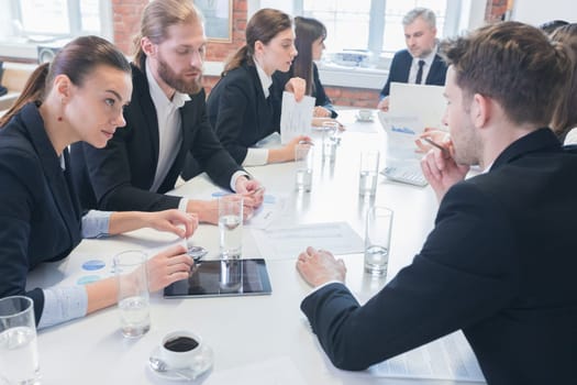 Business people at meeting in office discuss financial charts