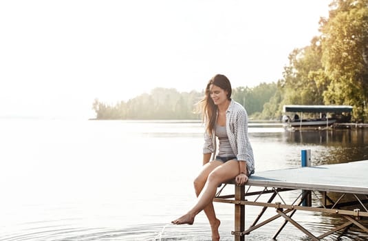 Lakeside getaway - Instant relaxation. an attractive young woman sitting on a pier.