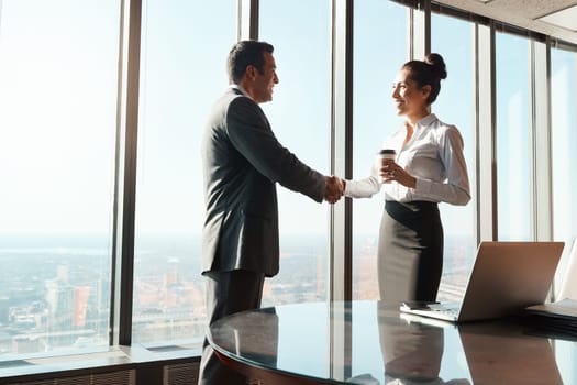 Networking is such a powerful tool in business. two businesspeople shaking hands in an office.