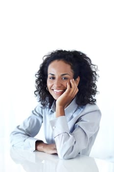 She brings her positivity to the workplace. Cropped portrait of an attractive businesswoman seated in studio.
