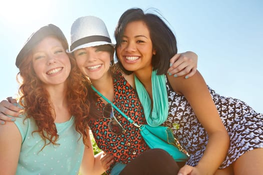 My friends are always there for me. Three teenage girls smiling happily with their arms around each other.