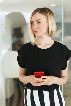 Business woman holding a smartphone in her