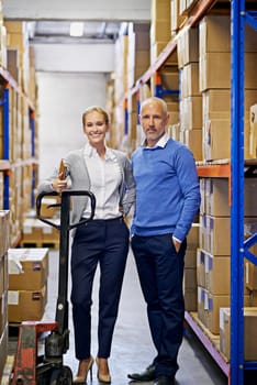 Weve got your order right here. Portrait of a man and woman inspecting inventory in a large distribution warehouse.