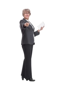 Happy mature woman pointing at camera with tablet pc on white background