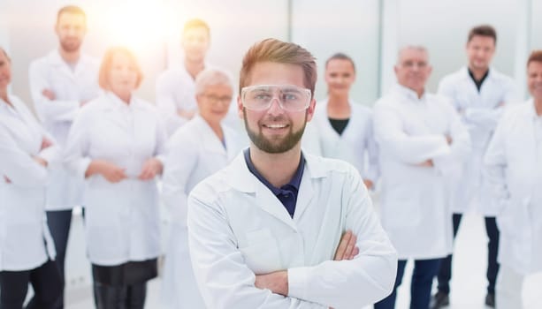 confident scientific leader standing in front of a team of young scientists.