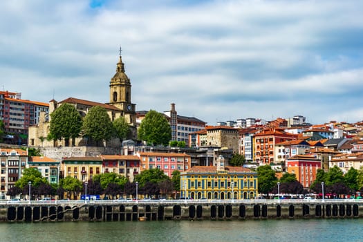 View of Portugalete town by Nervion river, and Sandra Maria basilica, Basque Country, Spain.