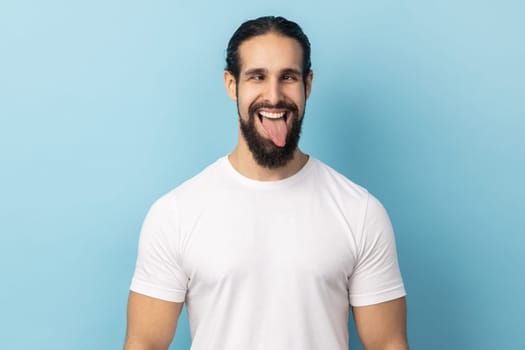 Man looking cross-eyed, having fun with silly face expression, showing tongue out.