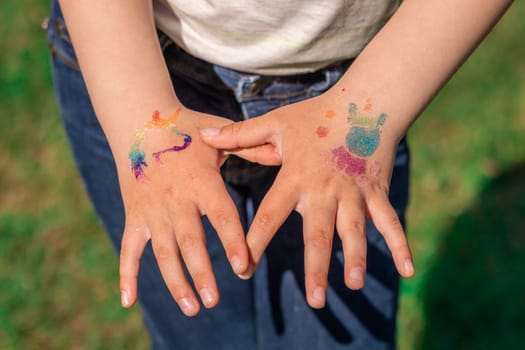 Shimmering sparkling glitter tattoo on a child's hand at a birthday party