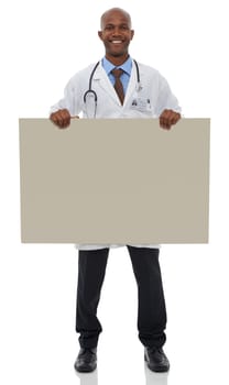 Endorsing your healthcare message. A young male doctor holding up a blank board