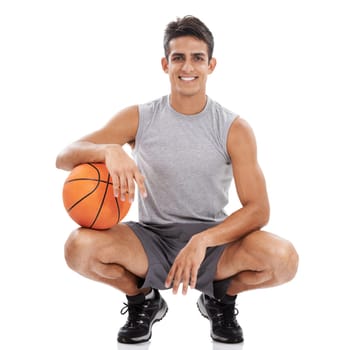 That was a good game. Portrait of a handsome young sportsman crouching with a basket ball under his arm.