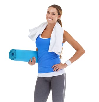 Pilates helps her stay in shape. Fit young woman holding a pilates mat with a smile - isolated on white.