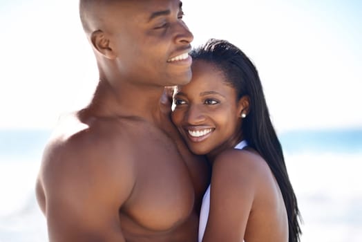 I found myself a real man... Finally. A happy african-american couple embracing on the beach.