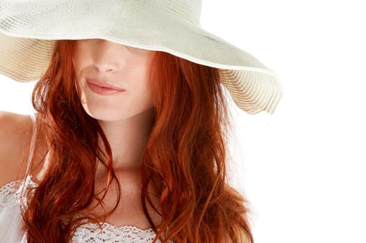 Woman, fashion and hiding with hat in white background, isolated studio and elegant style. Hidden face, mystery lady and female model with bold red hair, cool summer accessory and mysterious beauty
