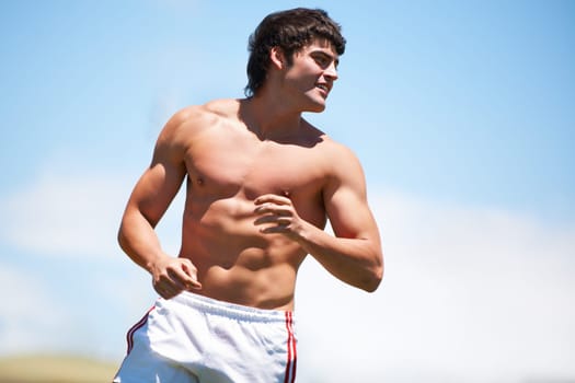 Making all the girls drool. a shirtless young athlete outdoors.
